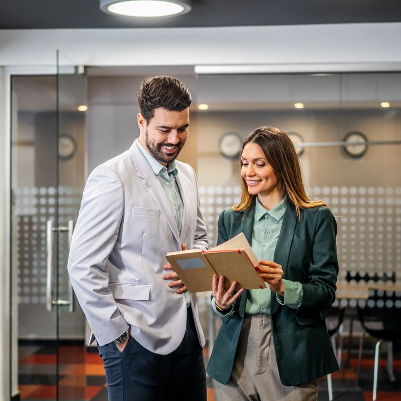 Business professionals collaborating discussing project in modern office, finding solutions and planning strategies for success