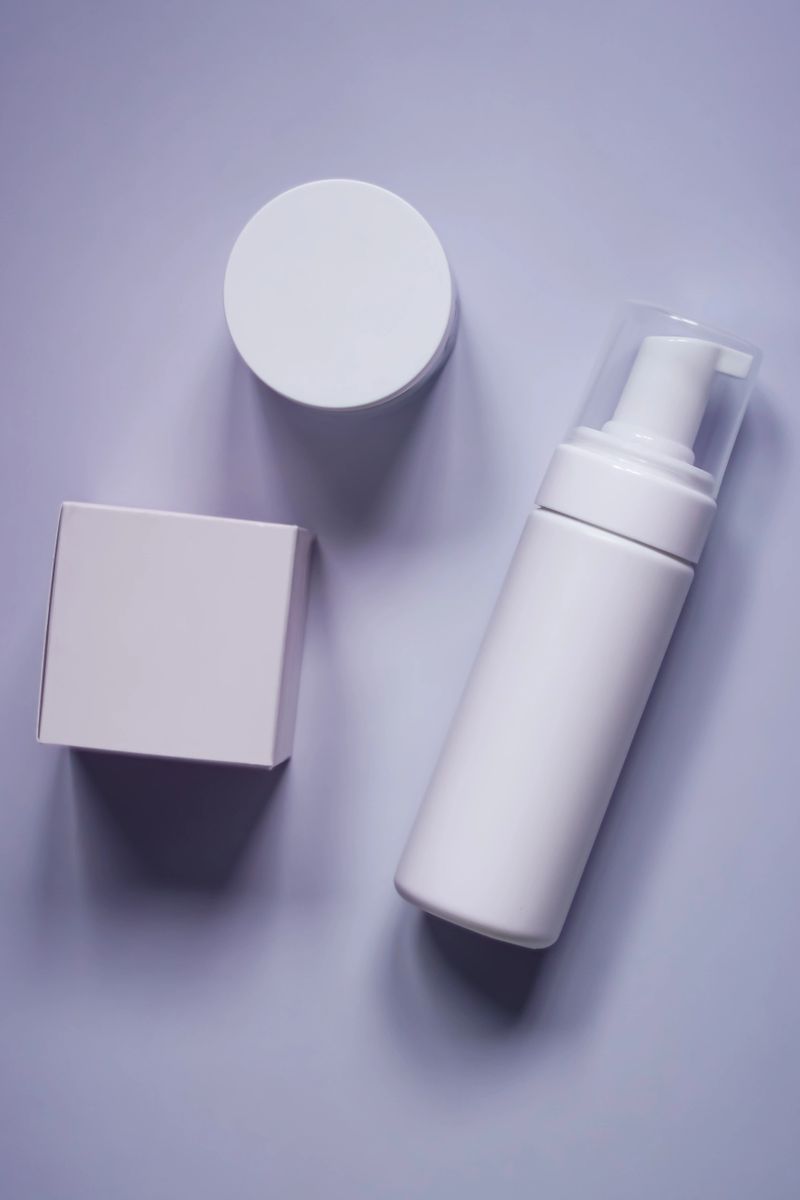 Skincare and beauty products in clean, minimalist white packaging for mockups, on a trendy pastel purple surface