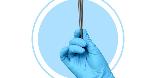 Hand in blue glove holding metal tweezers against blue and white background.