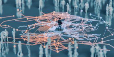 Businessman protecting a group of virtual people icons between his hands.