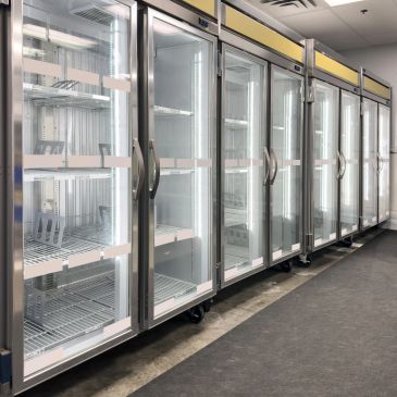 Empty commercial refrigerators with glass doors.
