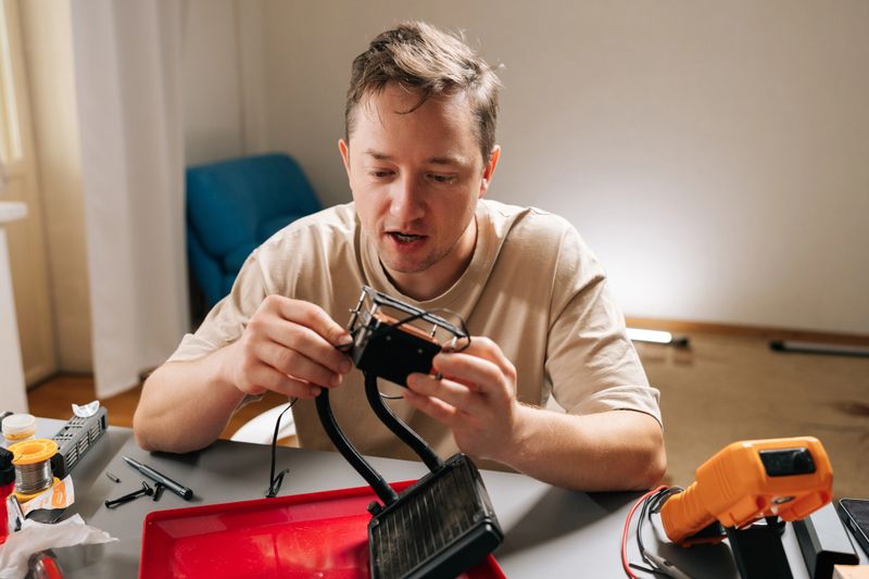 Portrait of skilled technician male repairing and installing computer liquid cooling system, showcasing pc building, technical support. Concept of computer hardware maintenance and upgrade.