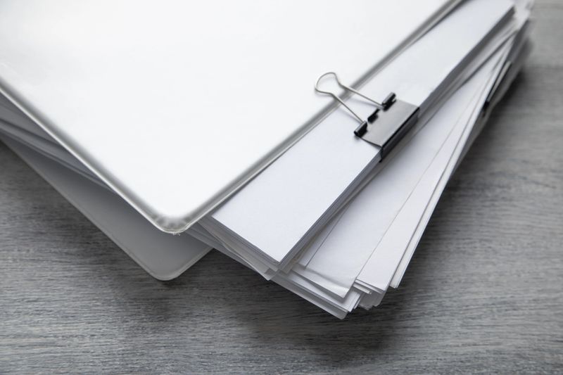 Stack of documents on the table.