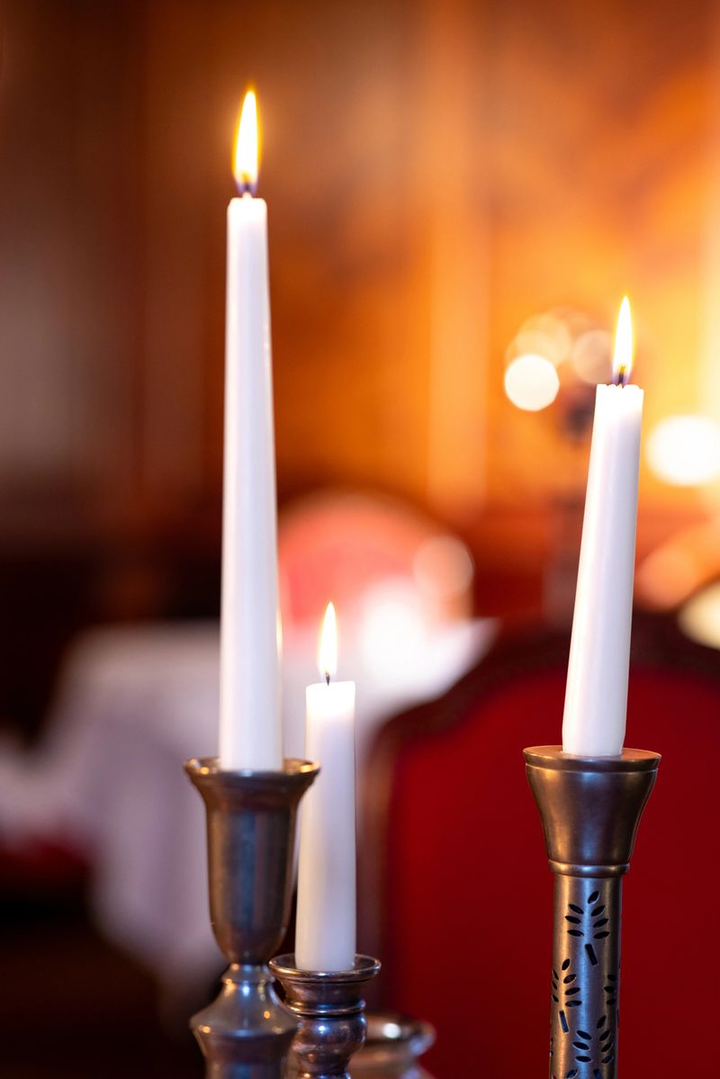 A close-up view of a candlelight burning on a luxury table setting for fine dining in a luxury modern hotel in Northumberland, North East England.