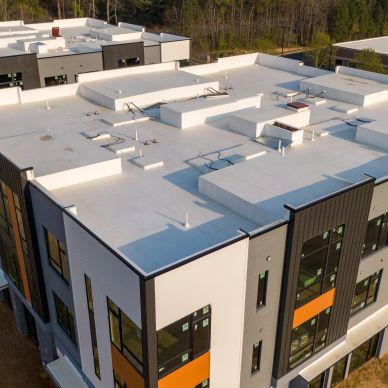 Aerial view of a modern flat-roofed building complex.