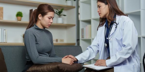 Doctor comforting a worried patient.
