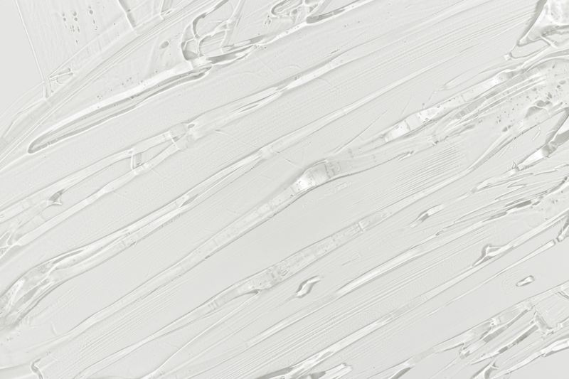 Close up background of transparent cosmetic gel, macro photo clear white color texture. Glossy texture and fluid shape emphasize hydration, moisturizing, purity, and modern skincare aesthetic