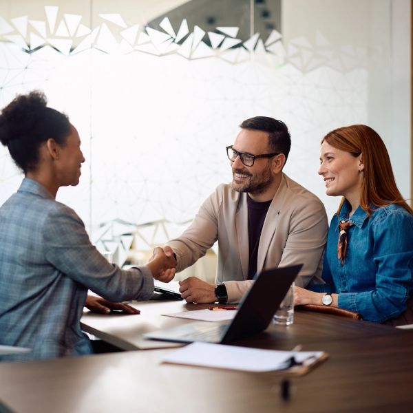 Professionals shaking hands during a meeting.