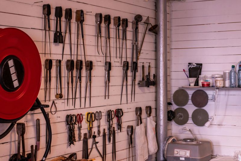 Organized workshop space. Tools and parts neatly arranged. Workshop filled with vintage metal components and labeled bins. Restorer meticulously arranging metal elements for restoration and creative reuse
