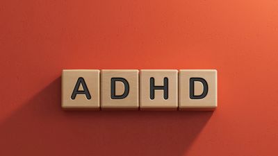 ADHD spelled out in wooden letter blocks. 