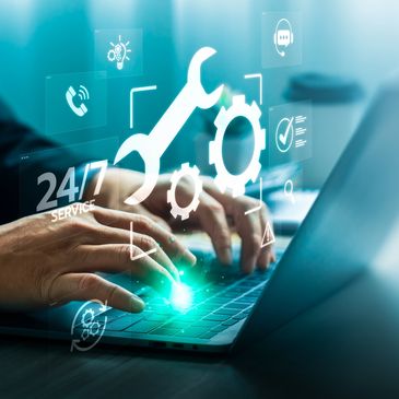 Hands typing on laptop with digital service icons.