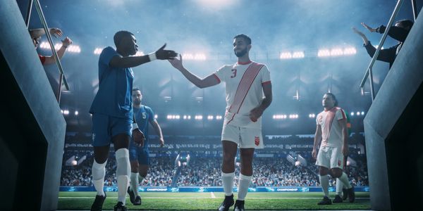 Soccer players greeting each other on a stadium field.