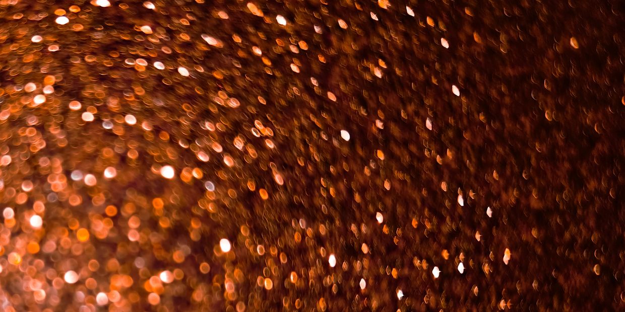 Blurred warm orange and brown lights creating a bokeh effect.