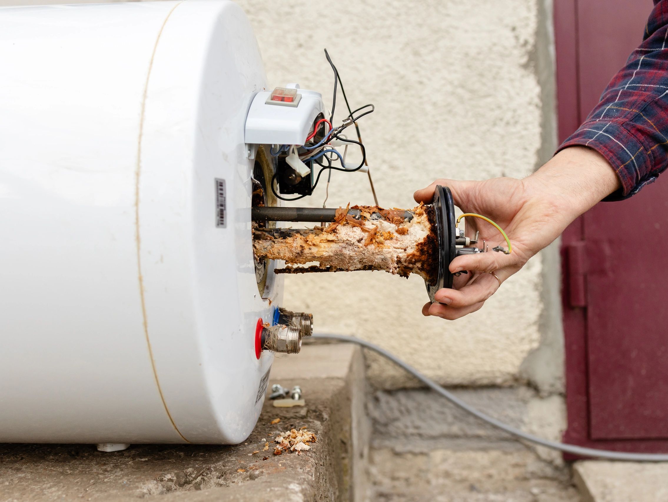 Technician repairing a tank water heater