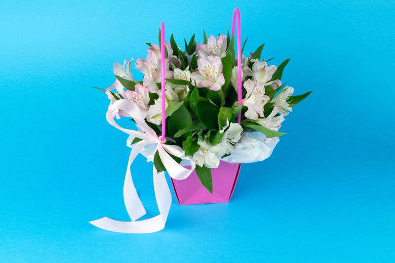 Elegant Pink Gift Basket with Fresh Alstroemeria Flowers on Blue Background