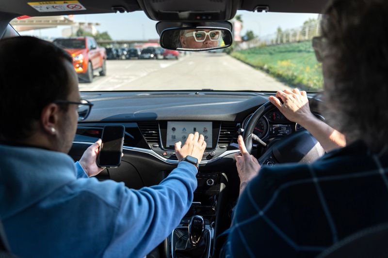 People in a car using modern technology for navigation, communication, and connectivity while driving