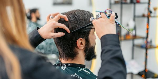 Man getting a haircut in a salon.