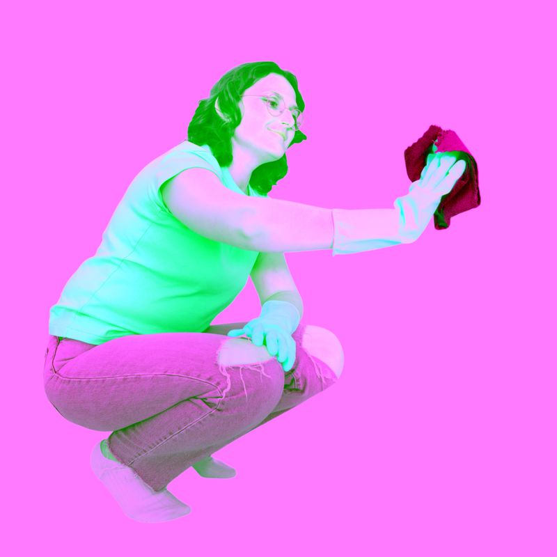 Woman cleaner wearing yellow rubber glove scrubbing surface with blue cloth. Housekeeper washing home or office interior. Professional cleaning service equipment for household maintenance.