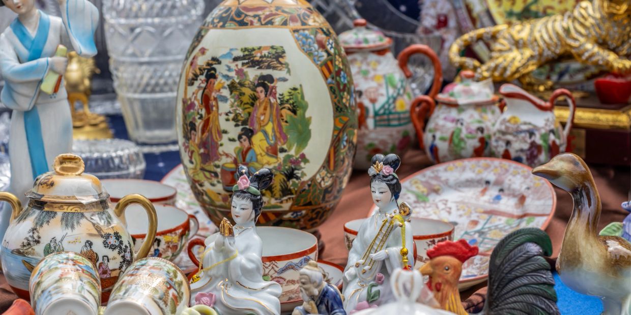 Intricately painted Asian porcelain figurines and vases.