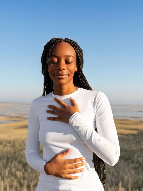Woman enjoying a peaceful moment outdoors.