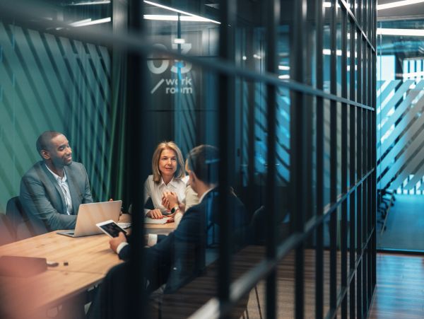 Three professionals having a meeting in a modern office room.