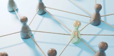 Wooden figures connected by strings forming a network.