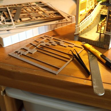 Materiali e strumenti per modellismo su un tavolo di legno.
