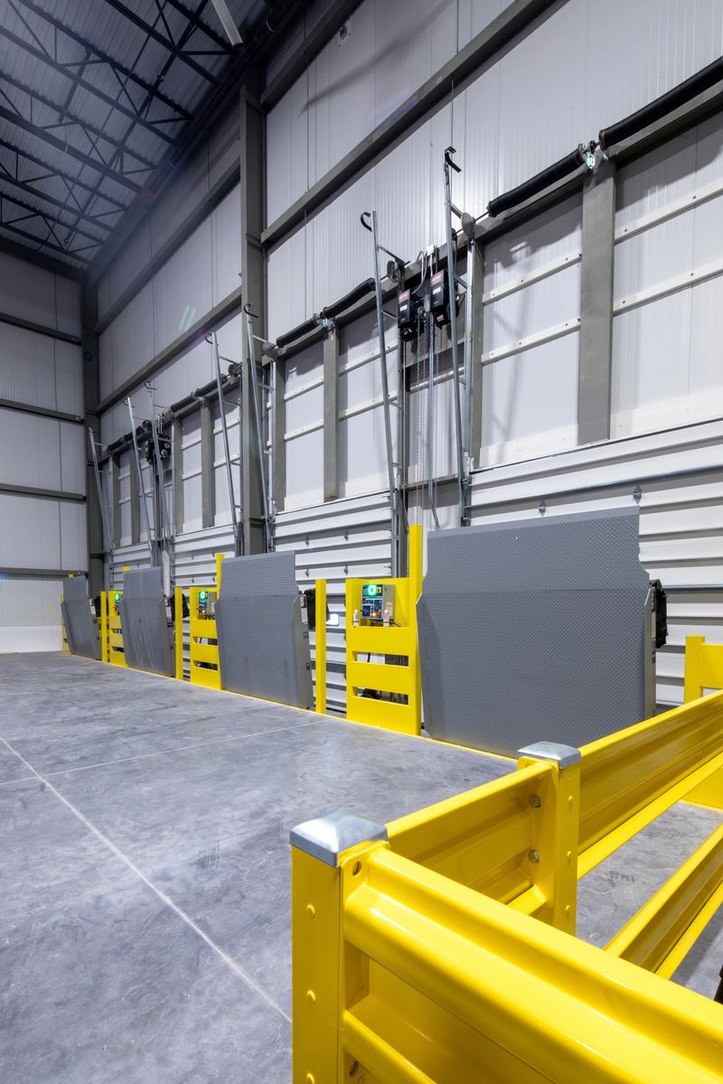 cold storage industrial freezer warehouse loading docks, and yellow steel barrier protection in the foreground