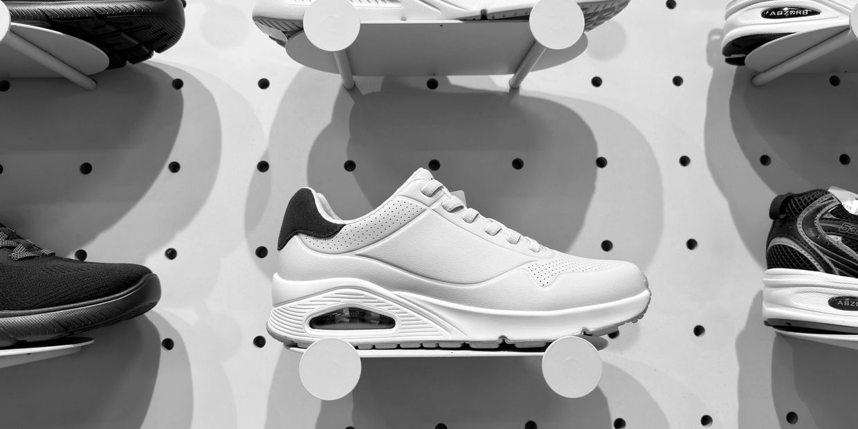 Running shoes and sports trainers on a shop shelf 