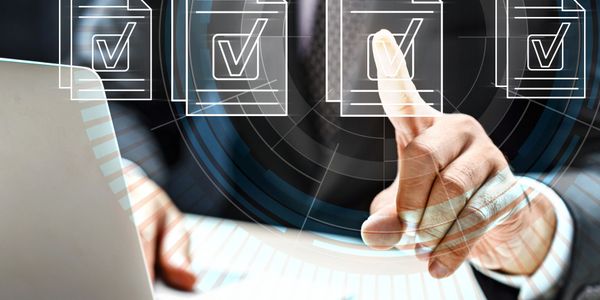Businessman interacting with digital checklists on a transparent interface.
