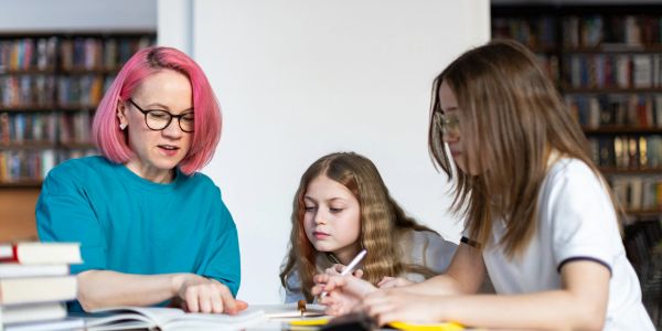 Three people studying together at a table.