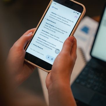 Person holding smartphone displaying a screen about WhatsApp services.