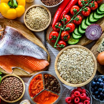 Assortment of healthy foods including fish, vegetables, grains, and spices.
