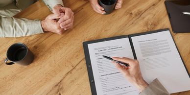 Two people discussing a document at a table.