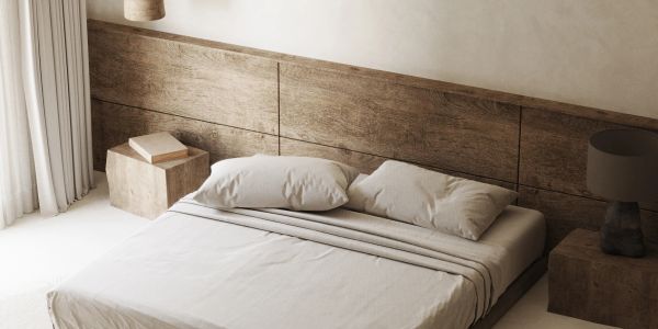 Minimalist bedroom with neutral tones and wooden accents.