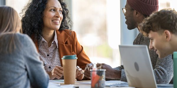 Colleagues engage in a positive discussion at a workplace.