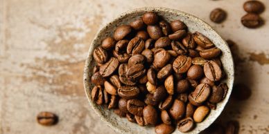 Bowl filled with roasted coffee beans.