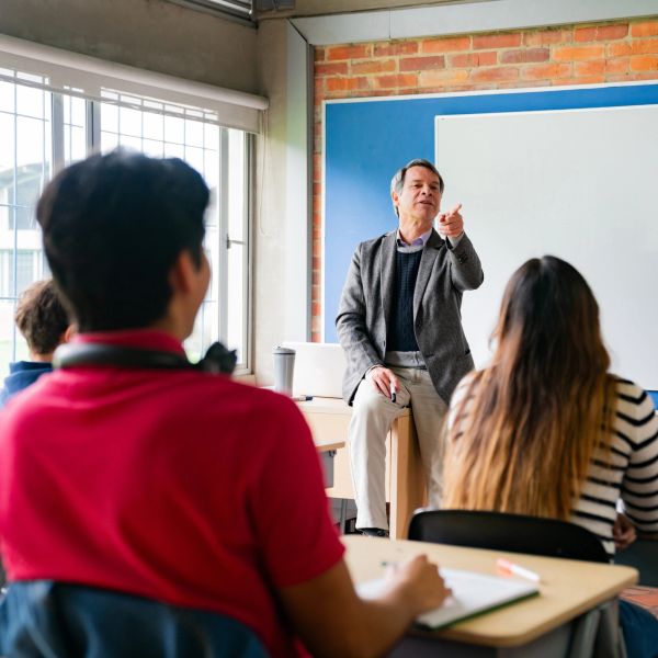 Teacher engaging with students in a classroom.