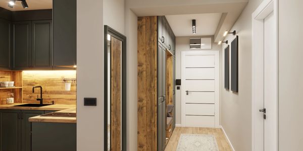 Modern hallway with wooden accents and adjacent kitchen area in neutral tones.