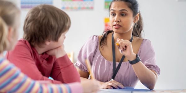 Teacher engaging with students in a classroom.