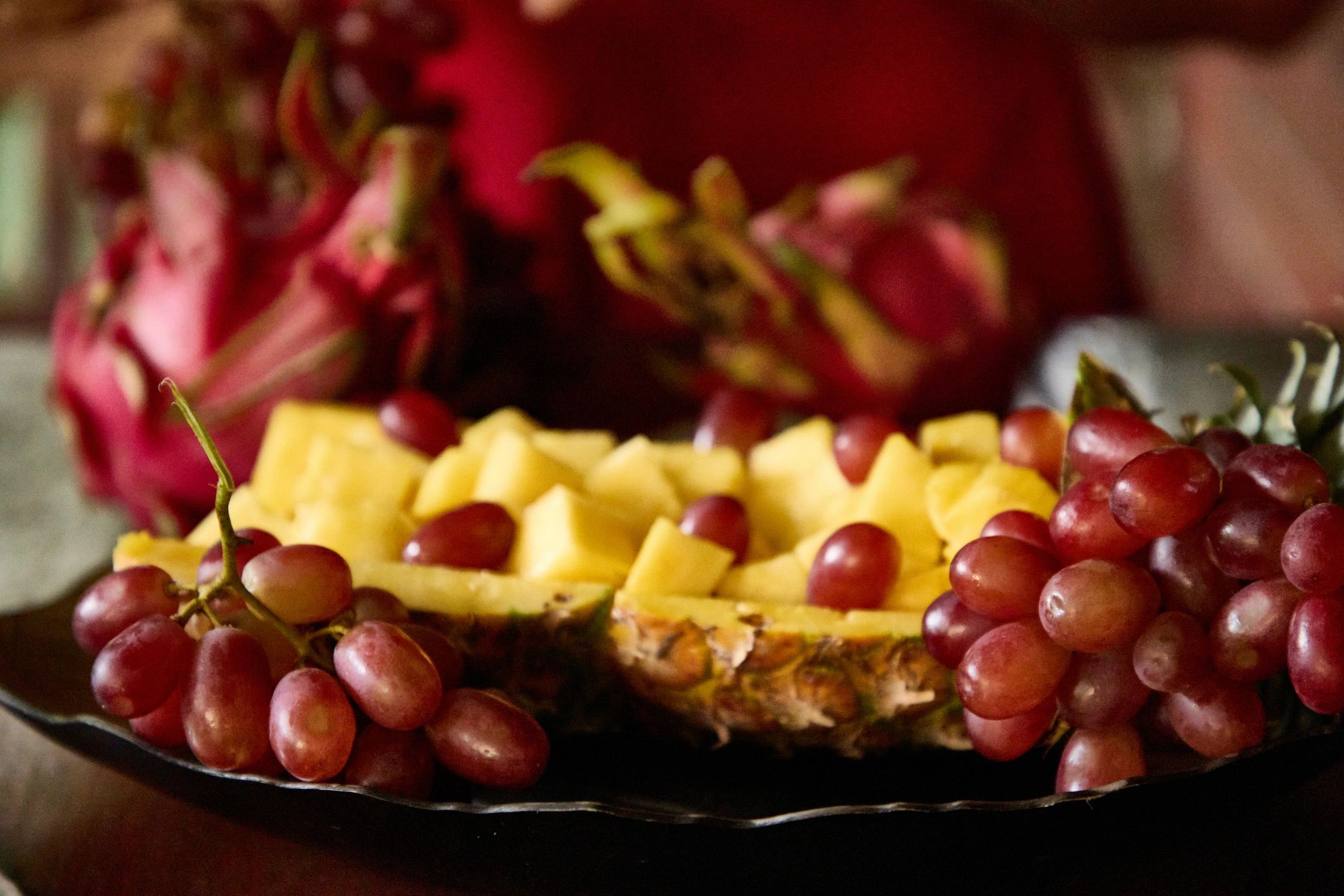 Grapes and diced pineapple in a shell.