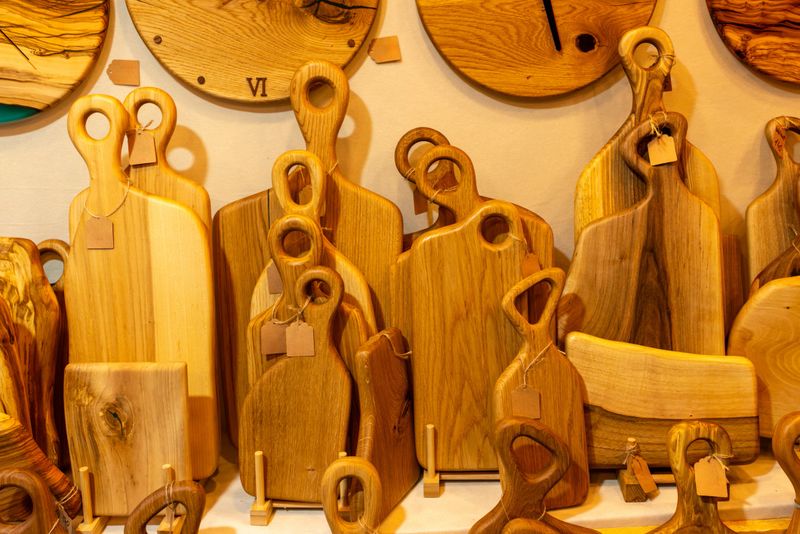 Collection of handmade wooden cutting boards in various shapes and sizes showcasing natural wood grain and smooth finish. Perfect for kitchen use, food preparation, serving, and rustic interior styling.