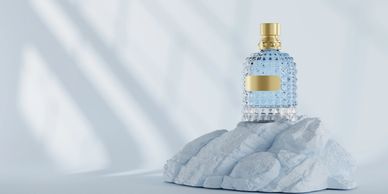 Decorative perfume bottle on textured stone.