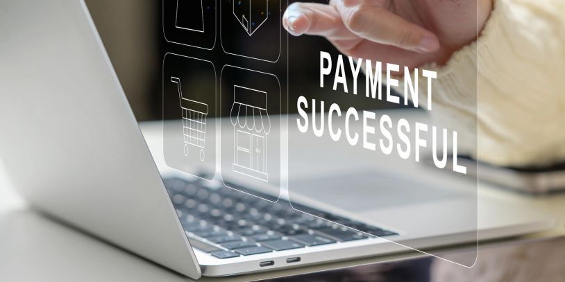 Person confirms successful online payment on a laptop screen.
