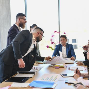 Business meeting with colleagues discussing documents.