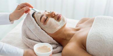 Woman receiving a relaxing facial mask treatment.