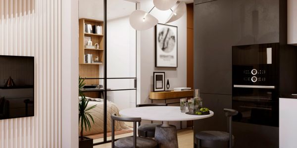 Modern dining area with round table and black chairs in a sleek kitchen space.