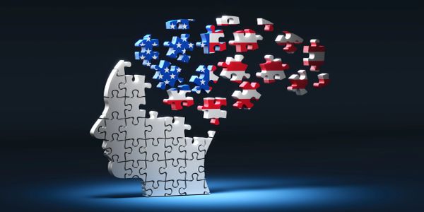 Puzzle head with American flag puzzle pieces floating away.