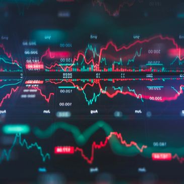 Colorful financial graphs and data visualizations on a digital screen.