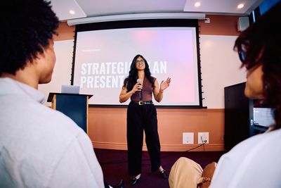 A woman gives a presentation to an audience.